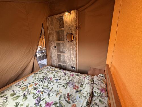 a bed in a room with a door at The Paddock in Bredon