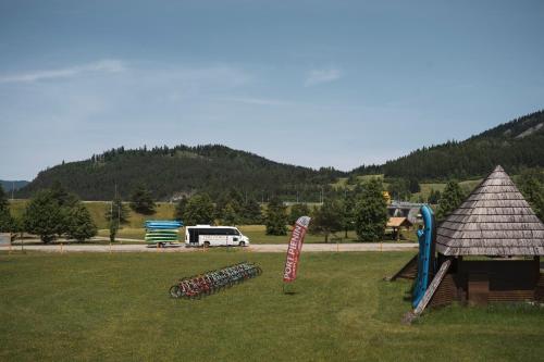 a group of bikes parked in a field next to a playground at Polana Sosny in Niedzica Zamek