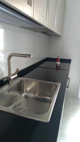 a stainless steel sink in a small kitchen at Casa vacanze " il muretto" in Gallipoli