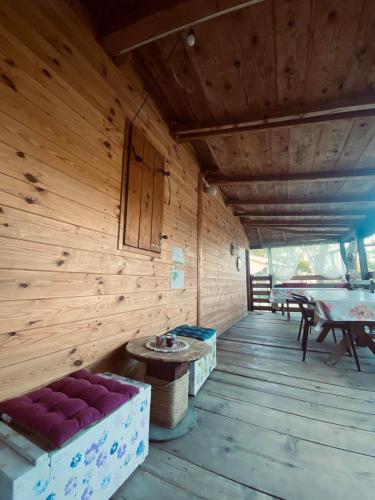 an inside of a wooden cabin with a table and a couch at Sunrise in Ulcinj