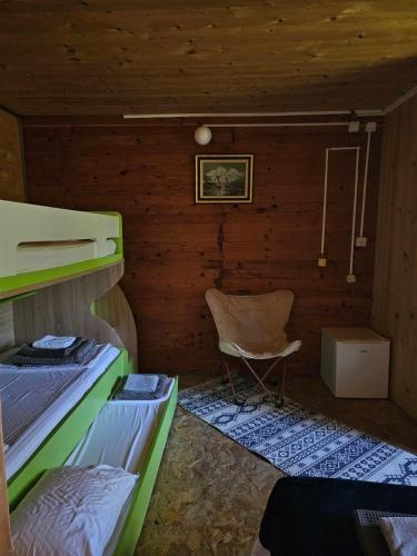 a room with two bunk beds and a chair at Sunrise in Ulcinj