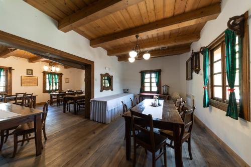 a dining room with tables and chairs and wooden ceilings at Polana Sosny in Niedzica Zamek