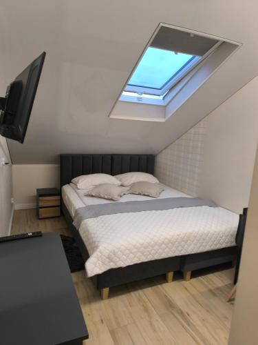 a bedroom with a bed and a skylight at Restauracja Dajana in Bełchatów