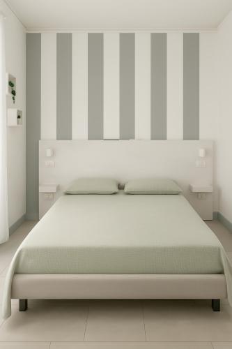 a white bedroom with a large bed in it at Guest House S Caterina in Viterbo