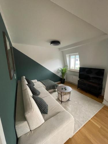 a living room with a couch and a table at Ferienwohnung Bad Reichenhall in zentraler Lage mit Bergblick in Bad Reichenhall