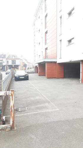 a car parked in a parking lot next to buildings at Elegant three bedroom apartment in Darlington