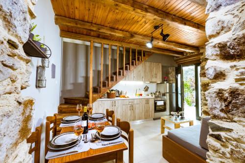 a kitchen and dining room with a table and chairs at Traditional Apartments Elafos in Elafonisi