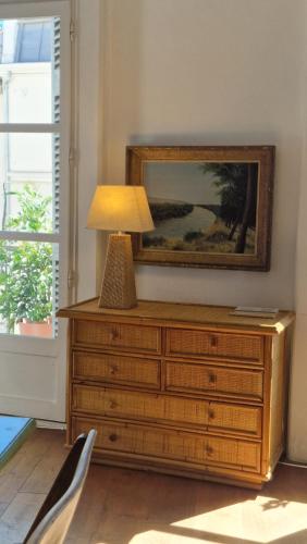 a lamp sitting on top of a dresser in a room at Apartment Joie de Vivre in Béziers