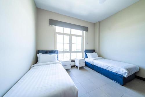 Postel nebo postele na pokoji v ubytování شقق التجوري Al-Tjouri Apartments