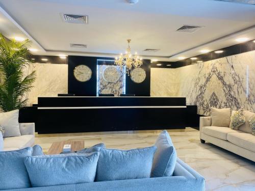 a living room with two couches and a piano at Aryaf Hotel Apart Tabasum Group in Ajman 