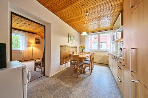 a kitchen and dining room with a table and chairs at Apartmán Svoboda in Svoboda nad Úpou