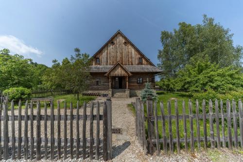 an old barn with a fence in front of it at Polana Sosny in Niedzica Zamek