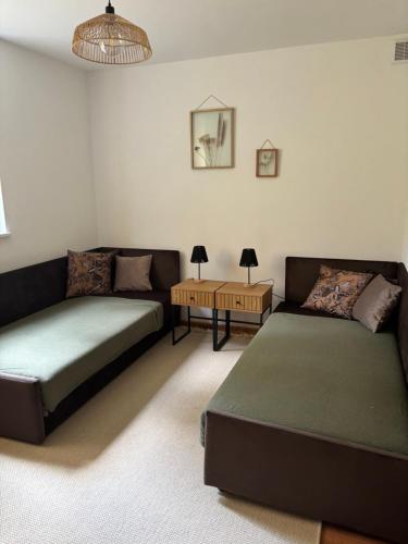 a living room with two beds and a table at Apartament Grzmięca pl in Grzmięca