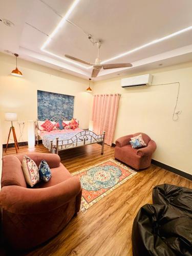 a living room with two couches and a bed at The Family Courtyard, 4 BR Boutique Villa and Guest House in Lucknow