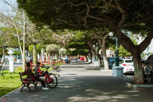 twee mensen op een bankje in een park bij Cozy 2BR Relaxing Vibe in Lima