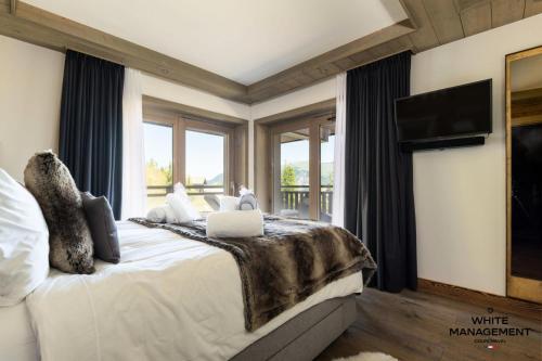 Кровать или кровати в номере Résidence Canyon Lodge - Chalet d'exception à Courchevel Moriond MAE-8904