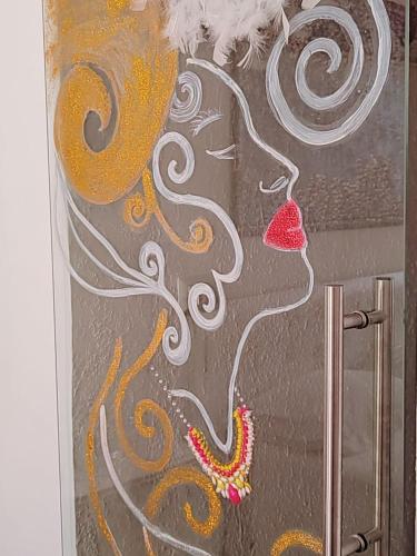 a painting of a woman with a red lips at Giardino Principi Dafagi in Capurso