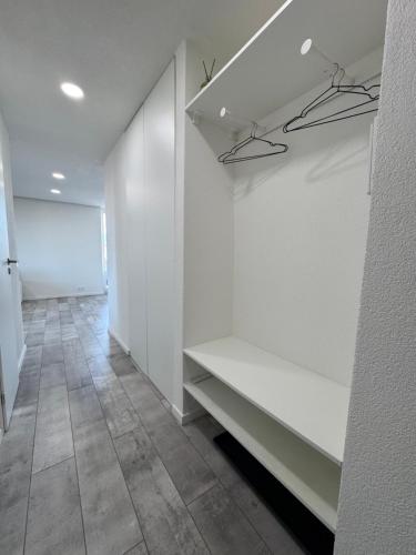 an empty hallway with white walls and tile floors at Urban apartment in Spišská Nová Ves