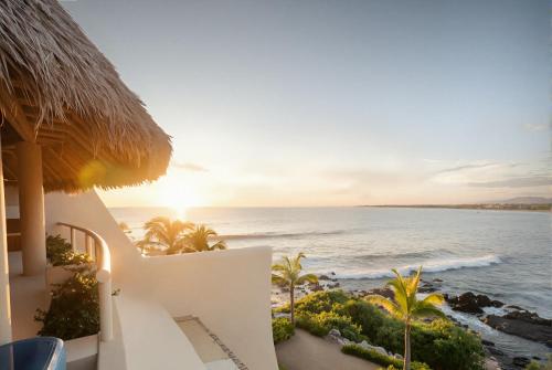 a view of the ocean from the balcony of a resort at Punta Majahua by PRC Hospitality in La Majahua