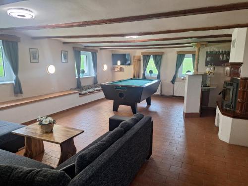 a living room with a pool table in it at Chalupa Háj in Jindřichovice