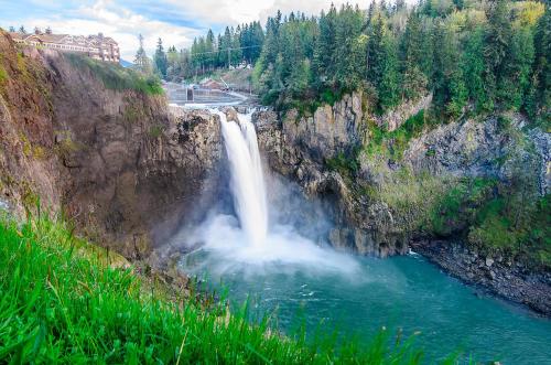 a waterfall in the middle of a river at Snoqualmie Inn by Hotel America in Snoqualmie