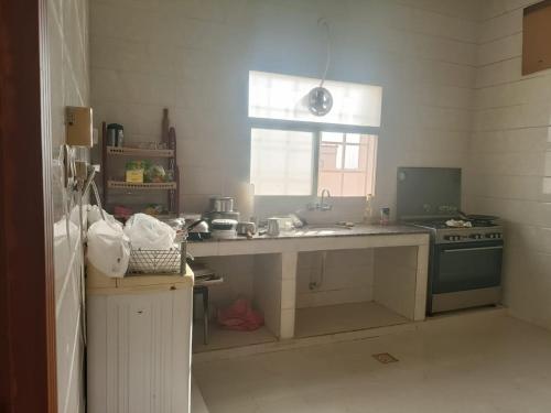 a kitchen with a sink and a stove at صحلنىوت الجنوبية in Salalah