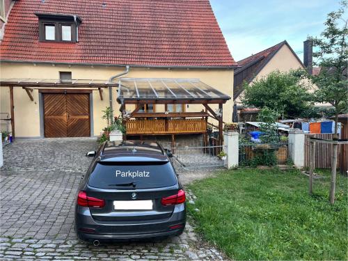 a car parked in front of a house at Altstadt Apartment mit Terrasse in Mainbernheim