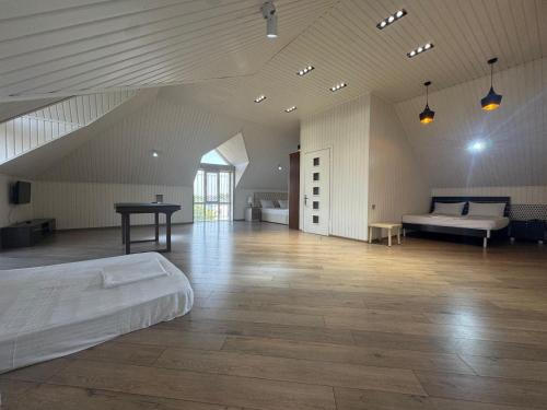 a large room with a bed and a table at villa pirşağı in Bilgah