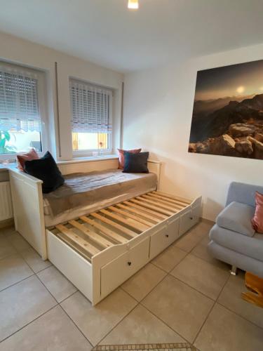 a large bed in a room with a couch at Ferienwohnung Bergliebe in Füssen