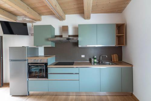 a kitchen with blue cabinets and a sink at Libera Mente in Fabriano