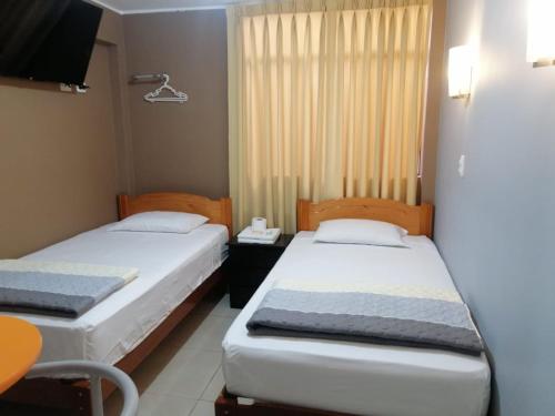 Кровать или кровати в номере HOSTAL LA NOCHE - Pisco