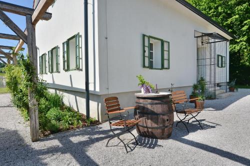 a group of chairs and a barrel next to a building at Pri Mimiki in Kamnica