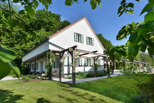 an exterior view of a white house with a yard at Pri Mimiki in Kamnica