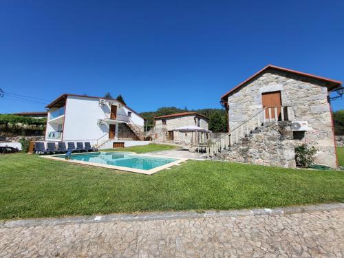 an external view of a house with a swimming pool at Quinta da Cachada in Lousada