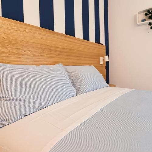 a bed with a wooden headboard in a bedroom at Guest House S Caterina in Viterbo