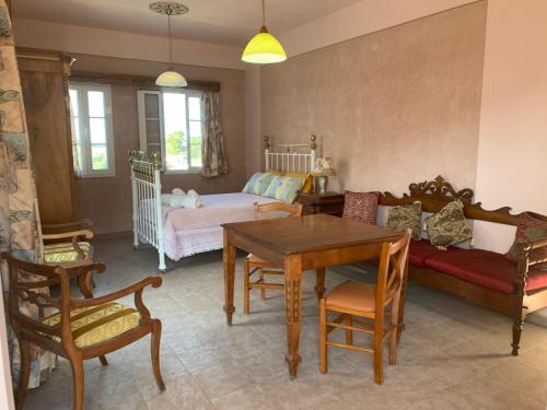 a living room with a couch and a table at Αρχόντισσα in Nisís Léros