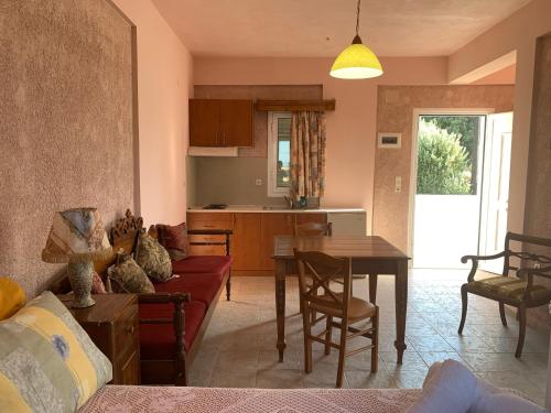 a living room with a couch and a table at Αρχόντισσα in Nisís Léros