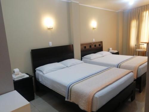 Кровать или кровати в номере HOSTAL LA NOCHE - Pisco