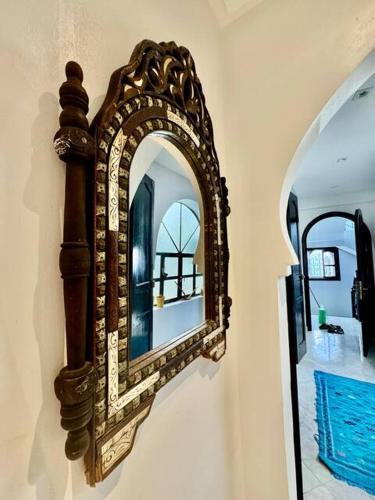 a mirror hanging on a wall in a room at Dar Larbi in Chefchaouene