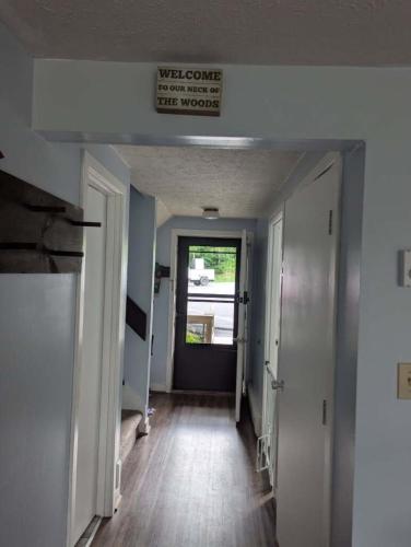 a hallway with a sign that reads welcome to the new house at Briarcliff C11 Condo in Sugar Mountain