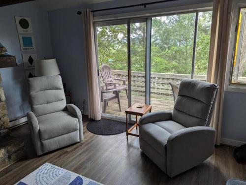 a living room with two chairs and a window at Briarcliff C11 Condo in Sugar Mountain