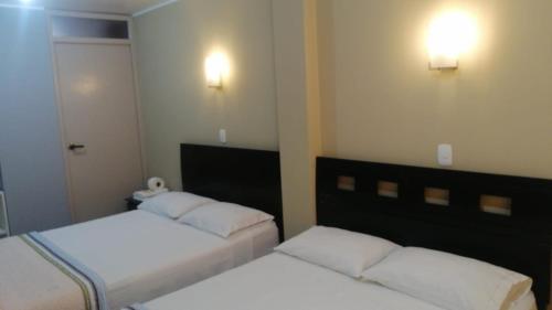 Кровать или кровати в номере HOSTAL LA NOCHE - Pisco