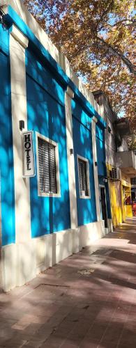a blue and white building with a sign on it at Hotel Gutierrez in Mendoza