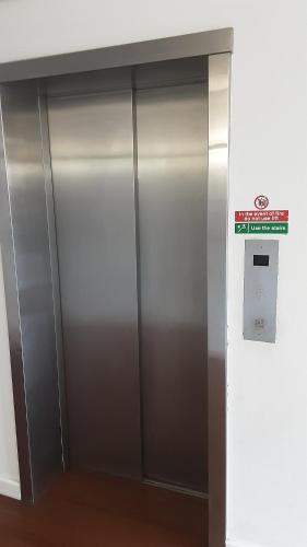 a metal elevator in a building with a sign on it at Elegant three bedroom apartment in Darlington