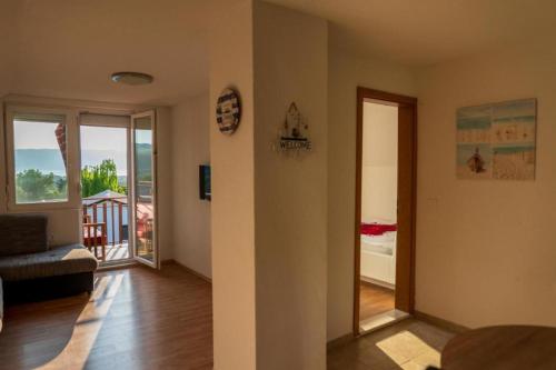 a living room with a view of a balcony at SUNSET Villa Apartments in Ohrid