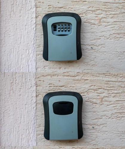 two black soap dispensers on the side of a wall at SUNSET Villa Apartments in Ohrid