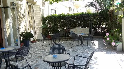a patio with tables and chairs in a courtyard at Hotel Eros in Lido di Camaiore
