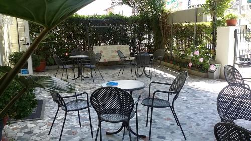 a group of chairs and tables and tables and chairs at Hotel Eros in Lido di Camaiore