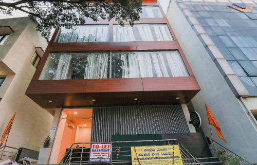 a building with a waterfall on the side of it at Capital O GN Suites in Bengaluru