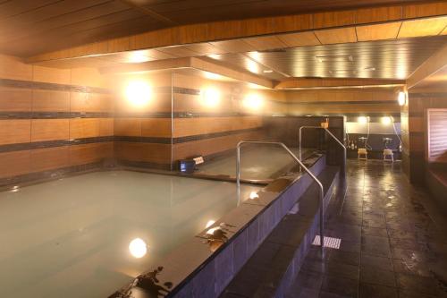 a large swimming pool in a room with at Kobe Port Tower Hotel in Kobe